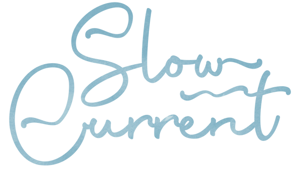 Cursive text 'Slow Current' in light blue watercolor on a transparent background